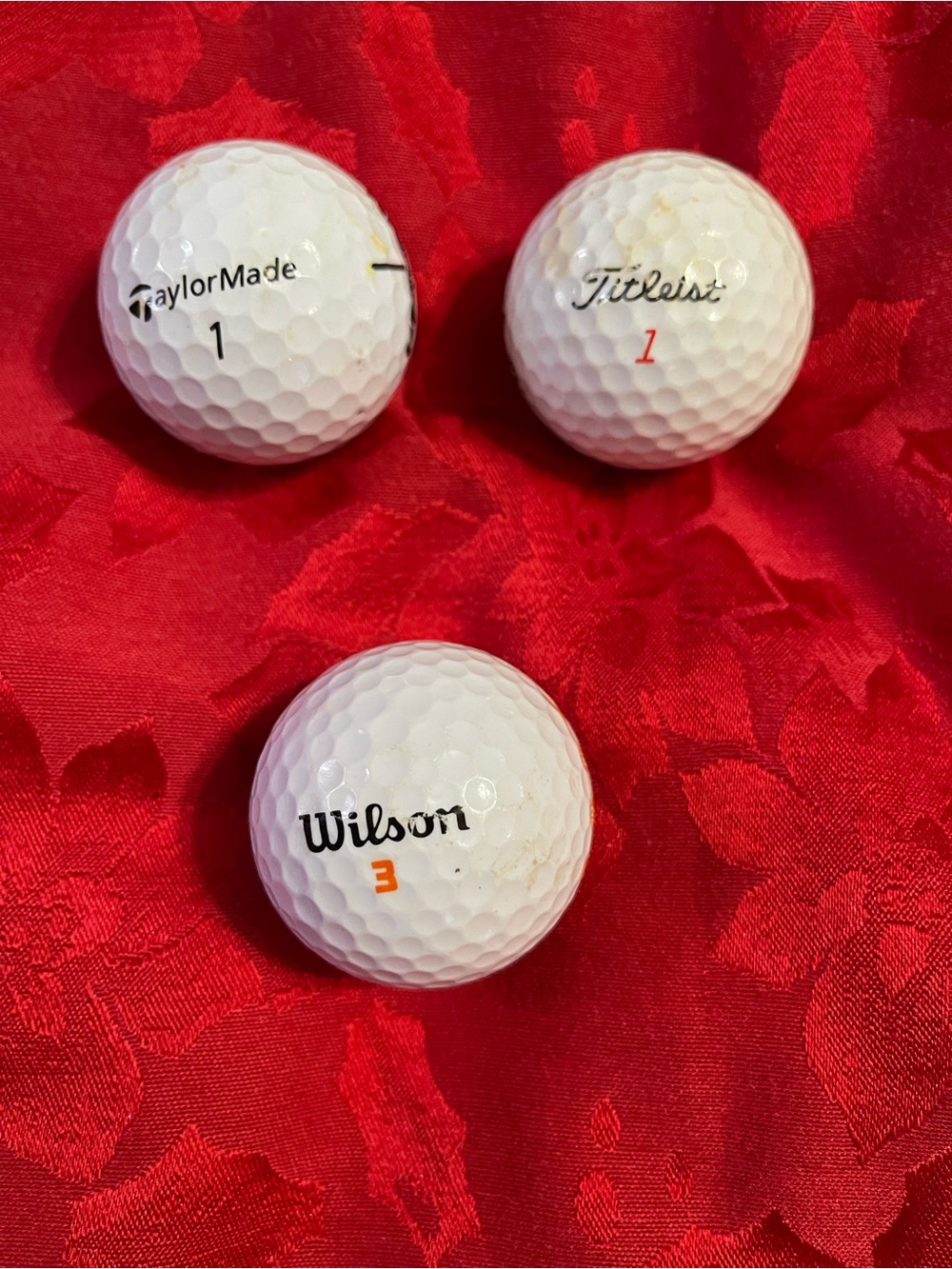 3 golf balls with logos on them!